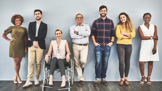 Shot of a diverse group of businesspeople standing against a wall